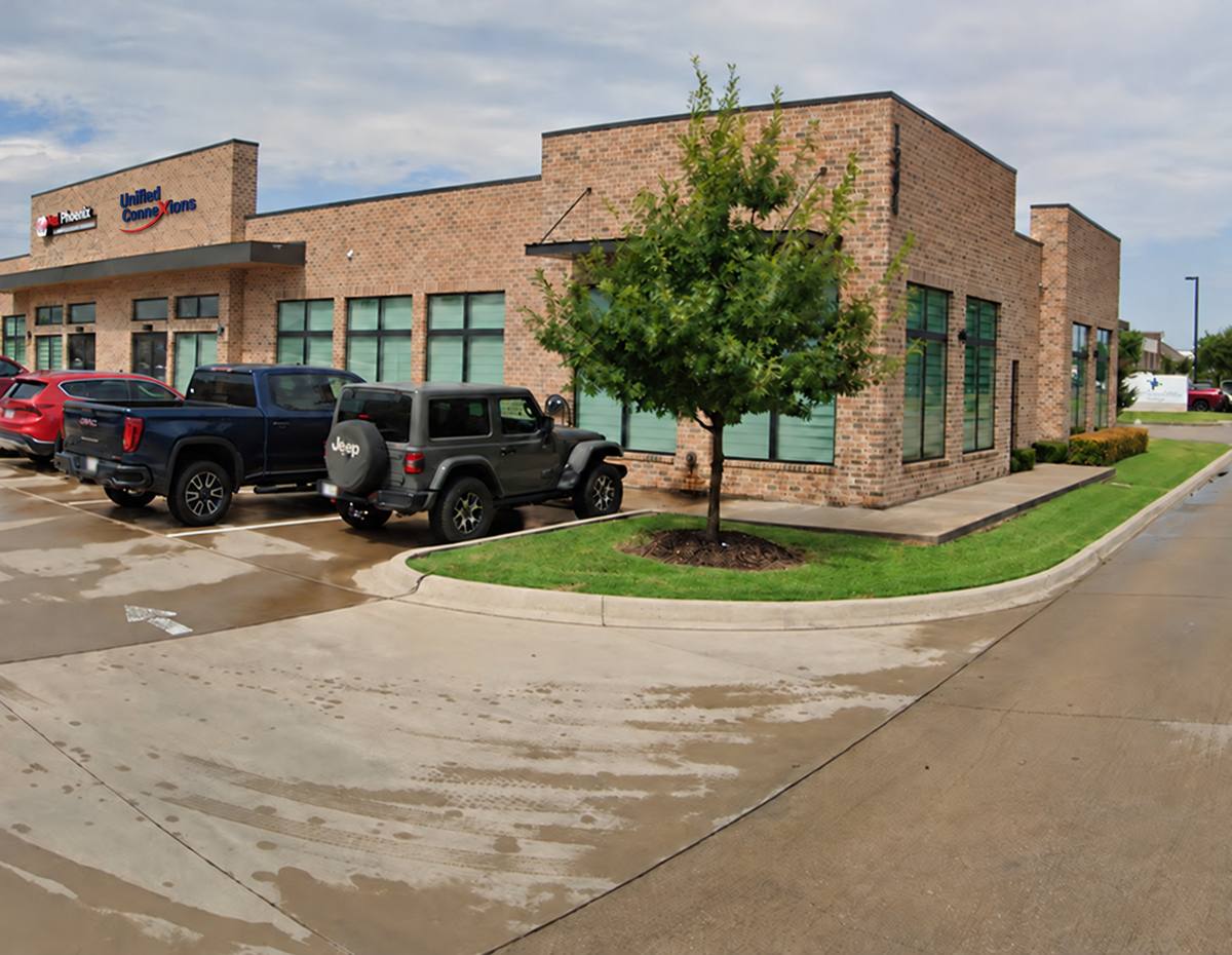 UCX office exterior in Waxahachie, with the UCX sign beside the neighboring Red Phoenix sign
